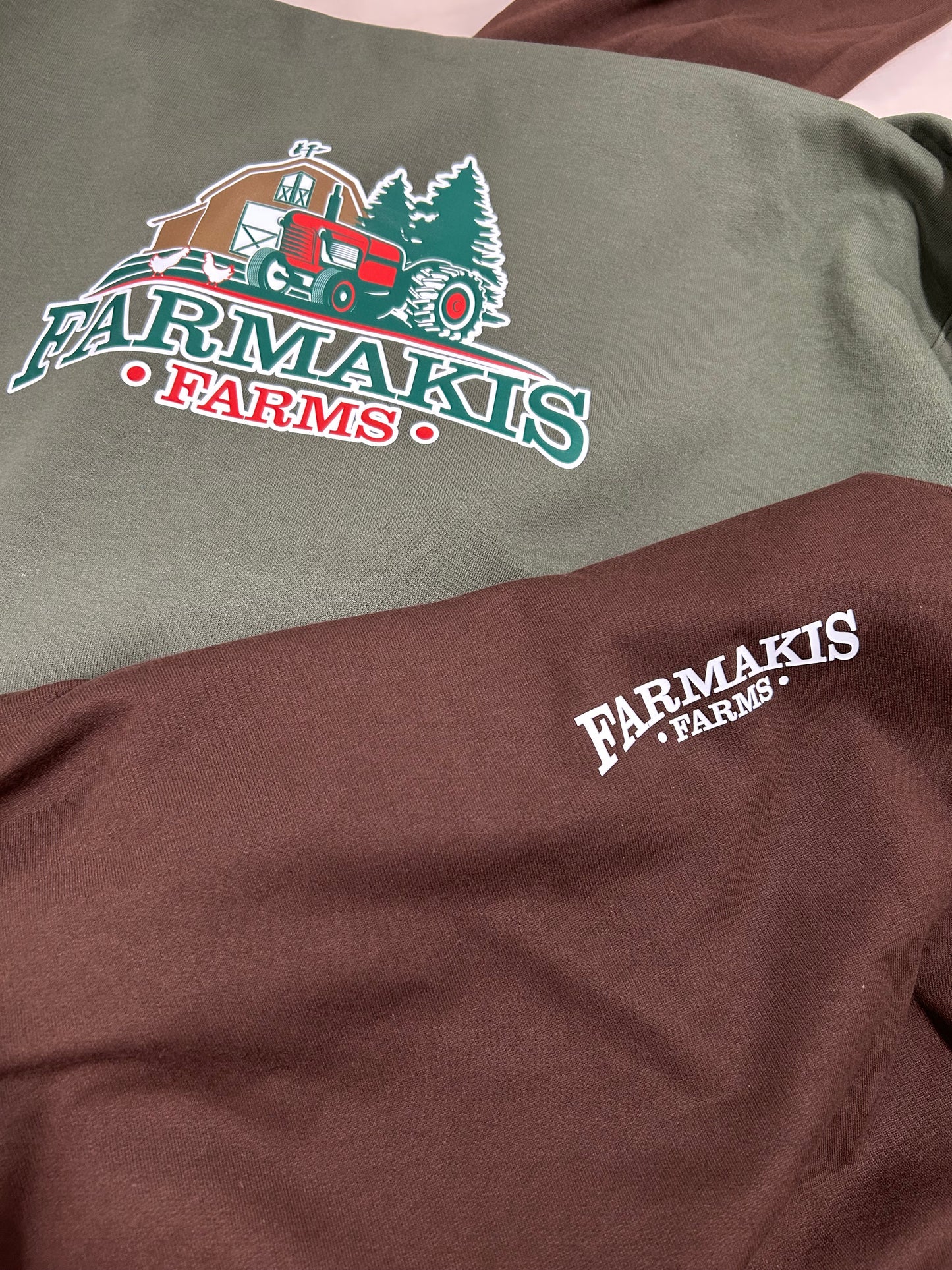 Two shirts with Farmakis Farms logo on a plain background