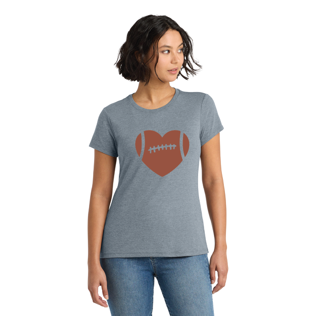 Woman wearing a gray t-shirt with a red heart and football design on a white background