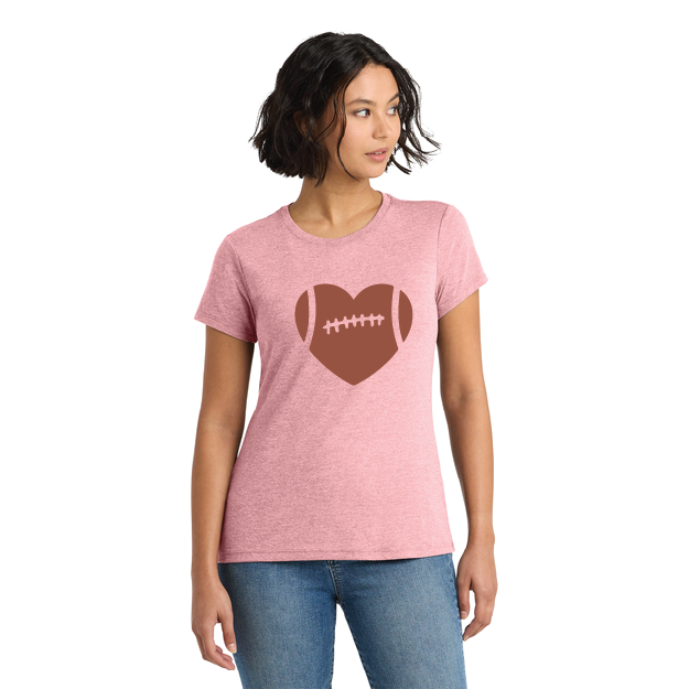 Woman wearing a pink t-shirt with a brown heart and football design on a white background