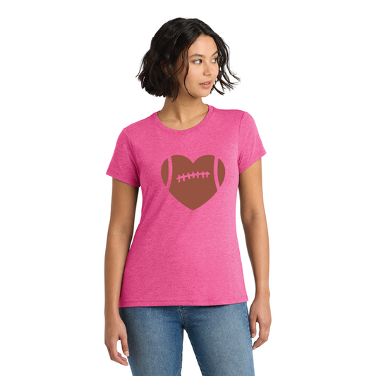 Woman wearing a pink t-shirt with a brown heart-shaped football design on a white background