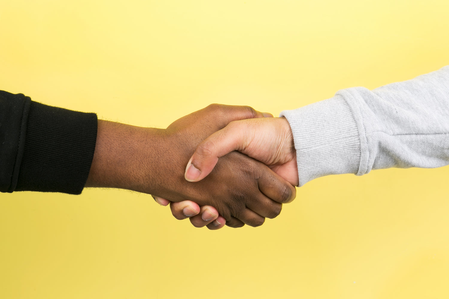 A professional hand shake symbolizing a strong business relationship, partnership, or agreement. This image represents trust, collaboration, and mutual respect in a business setting, often seen in meetings, negotiations, or networking events. Ideal for showcasing teamwork and successful partnerships.