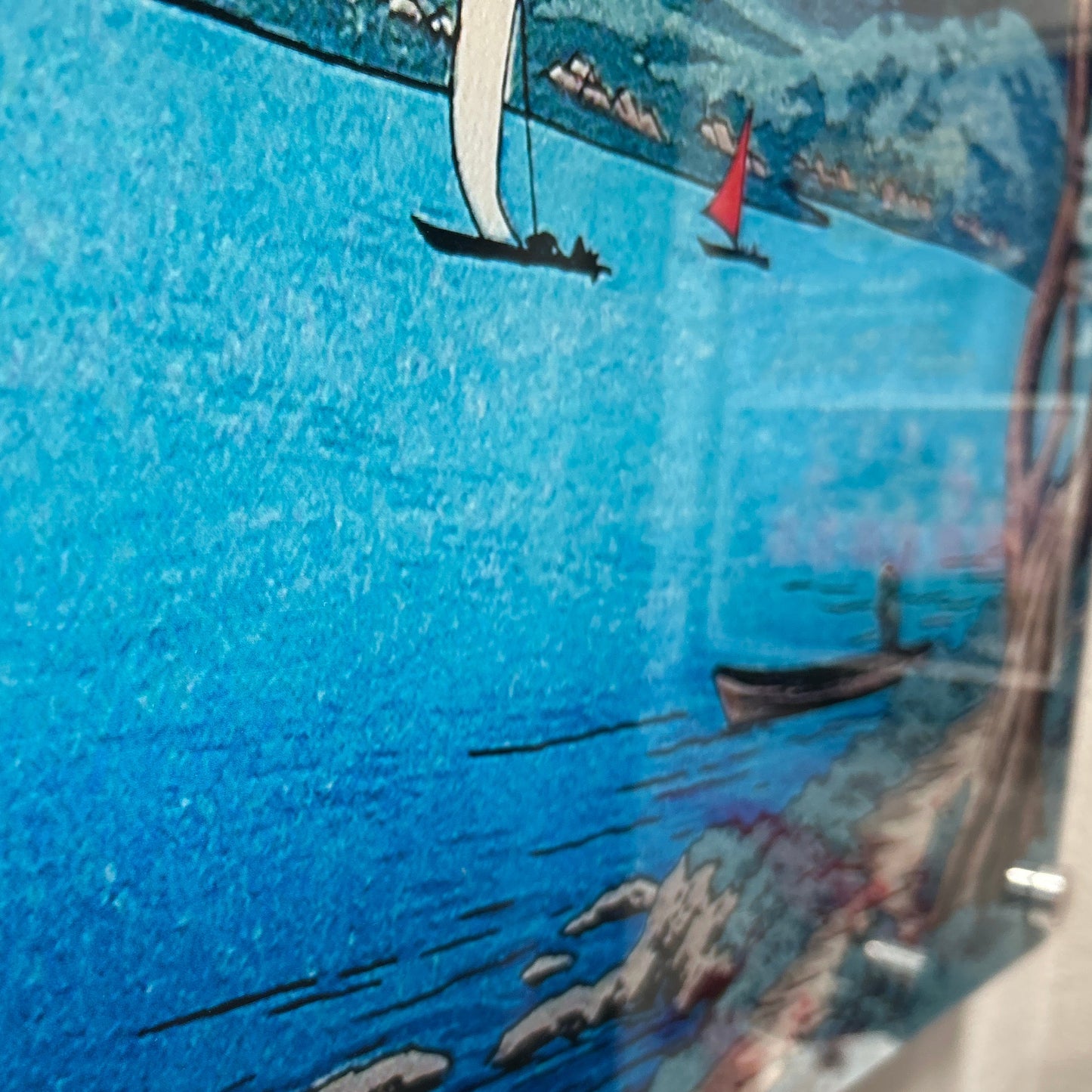 An acrylic print featuring a vibrant image of boats on water with a blue sky.