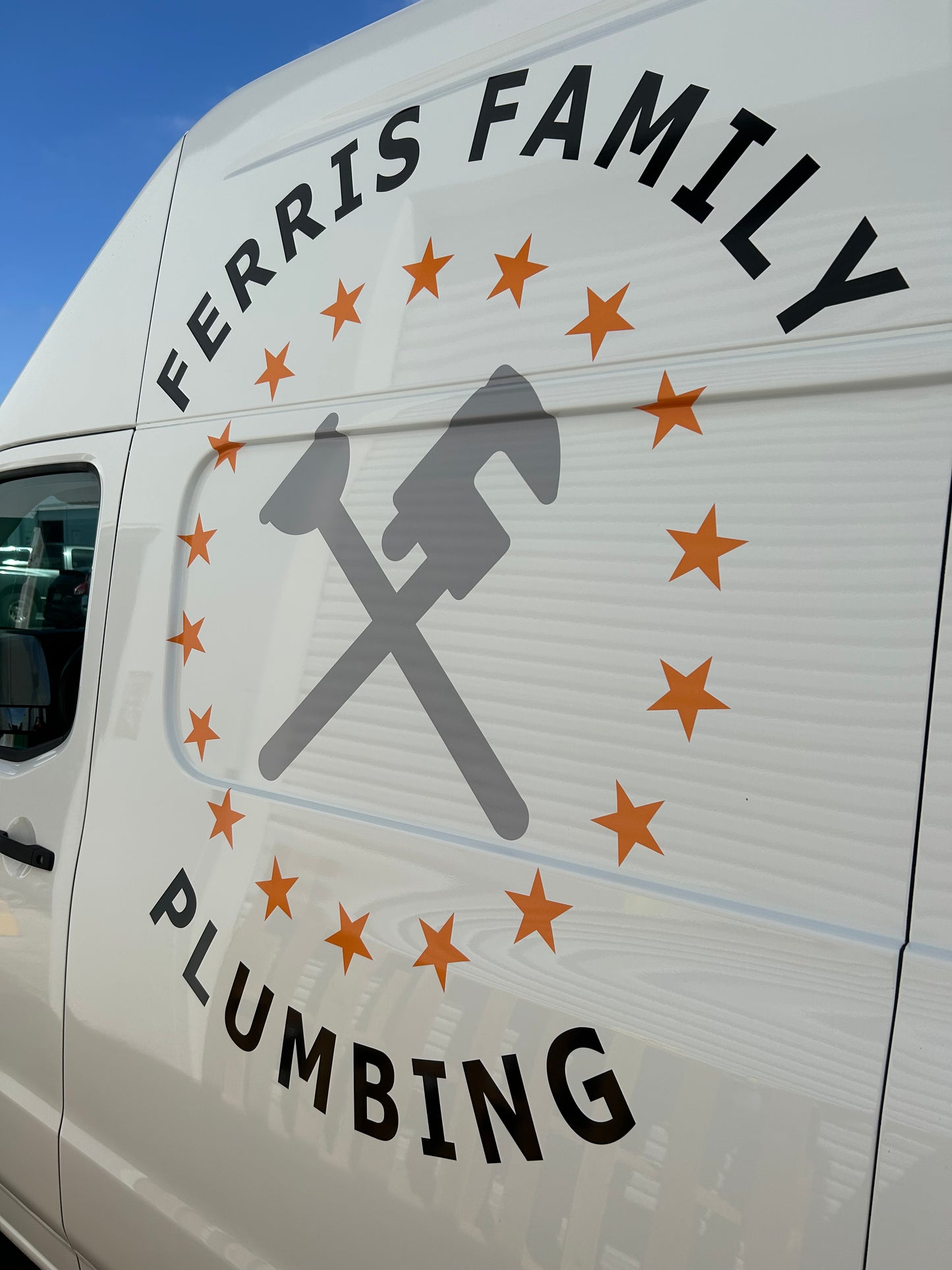 Plumbing company logo on a vehicle with text 'Ferris Family Plumbing'.