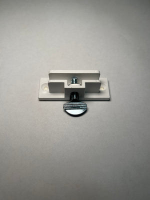 A single white PVC clip with two holes and an screw for perpendicular sign mounting on a grey background.