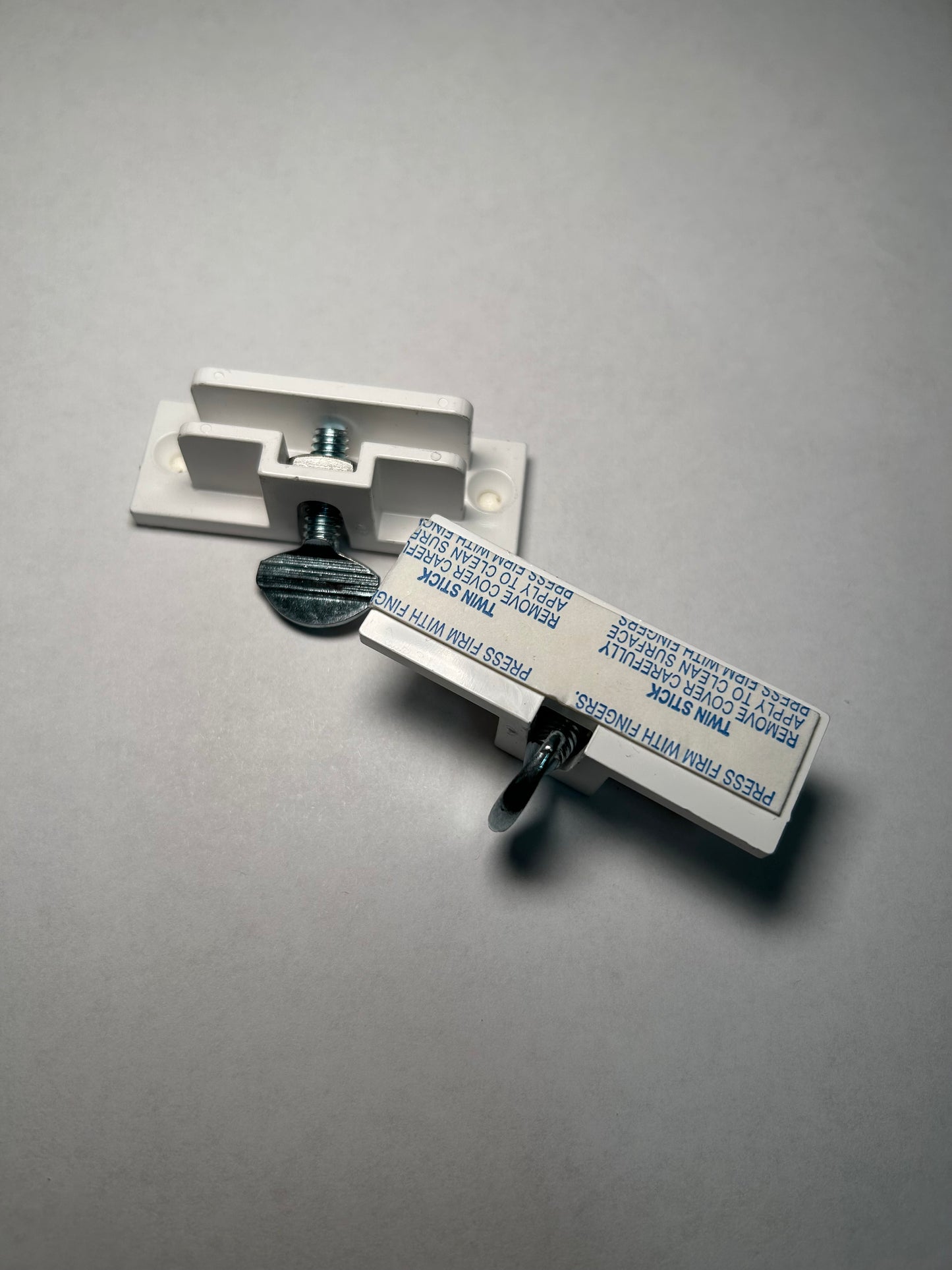 Metallic wall mount bracket on a gray background