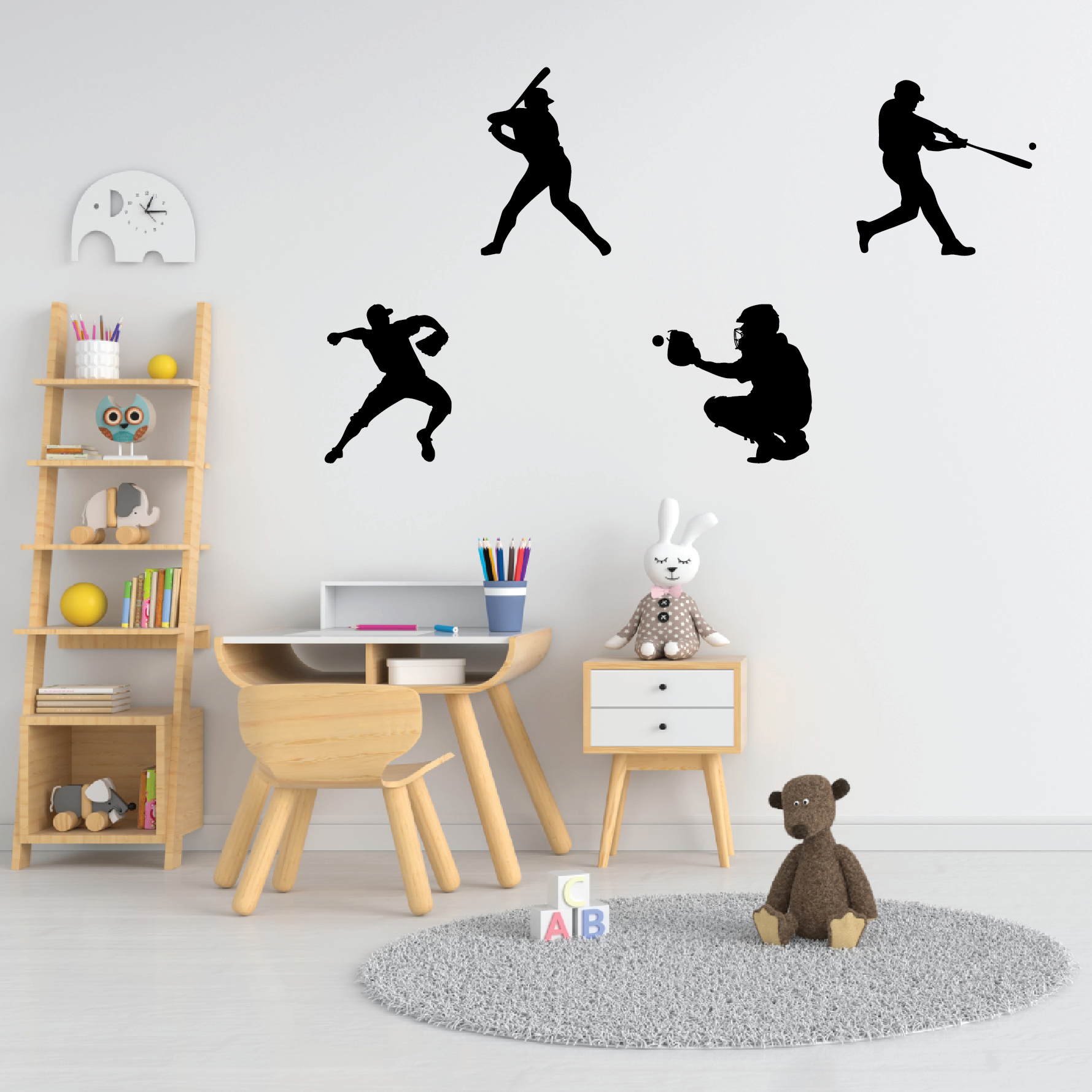A collection of baseball-themed vinyl wall decals in various poses, displayed on a wall in a children's room with a wooden table, shelves, and a teddy bear.