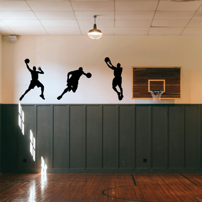 A vinyl decal of a basketball player in mid-dunk, applied on a wall in a gymnasium setting, with natural light falling on it.