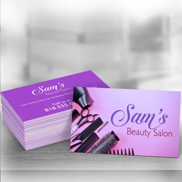 Stack of 'Sam's Beauty Salon' business cards with salon tools on a gradient background