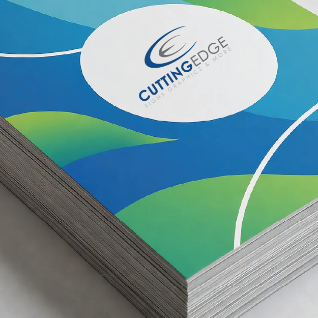 Stack of printed paper with Cutting Edge Graphics Services logo on a blue and green abstract design.