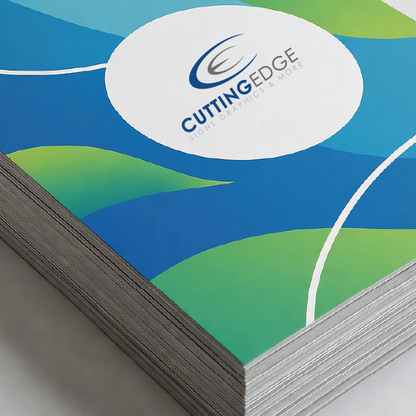 Stack of printed paper with Cutting Edge Graphics Services logo on a blue and green abstract design.