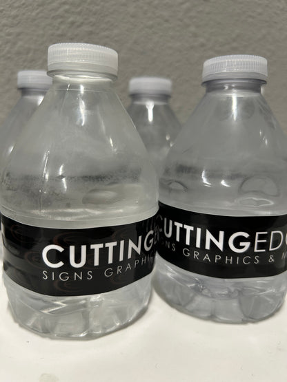Three clear plastic bottles with black labels on a gray surface