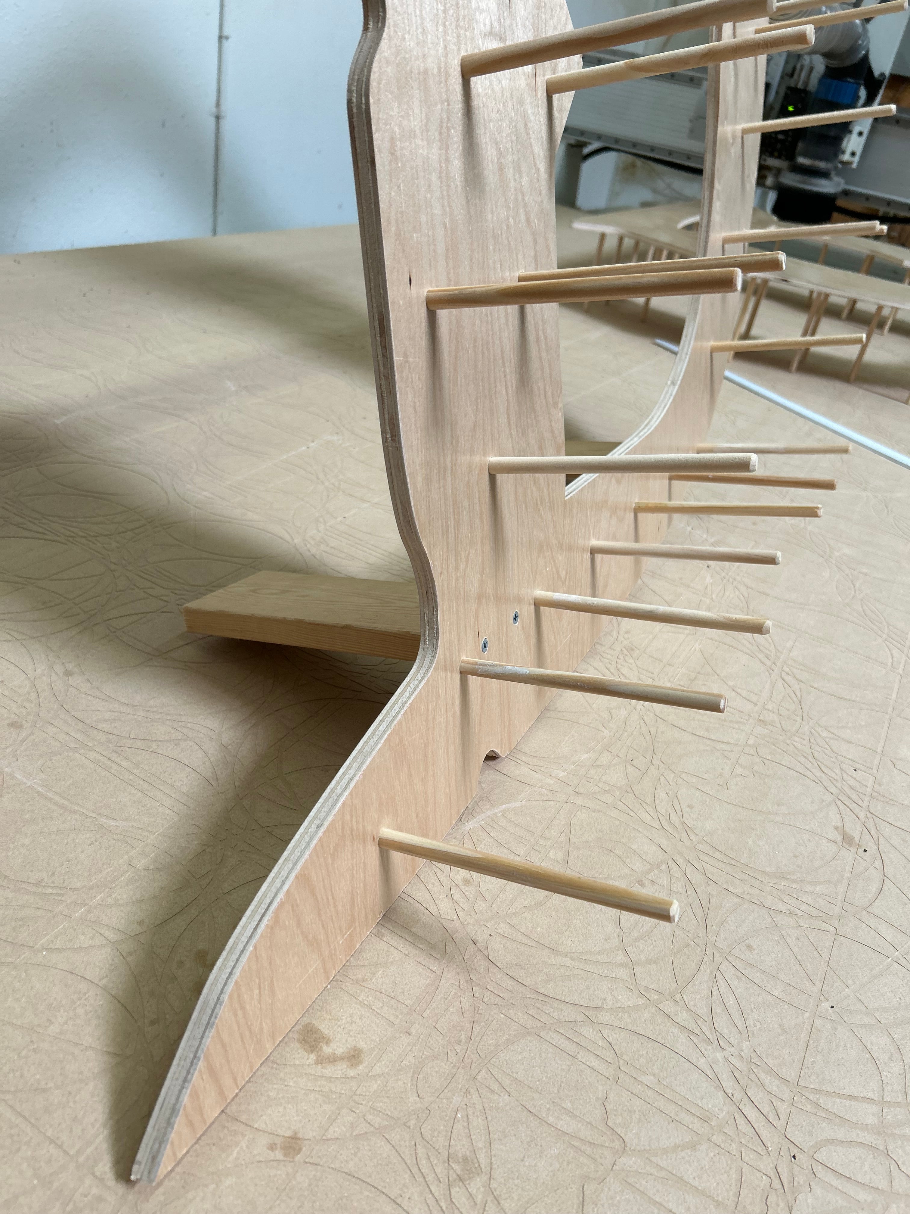 Wooden furniture piece with curved design on a textured wall background