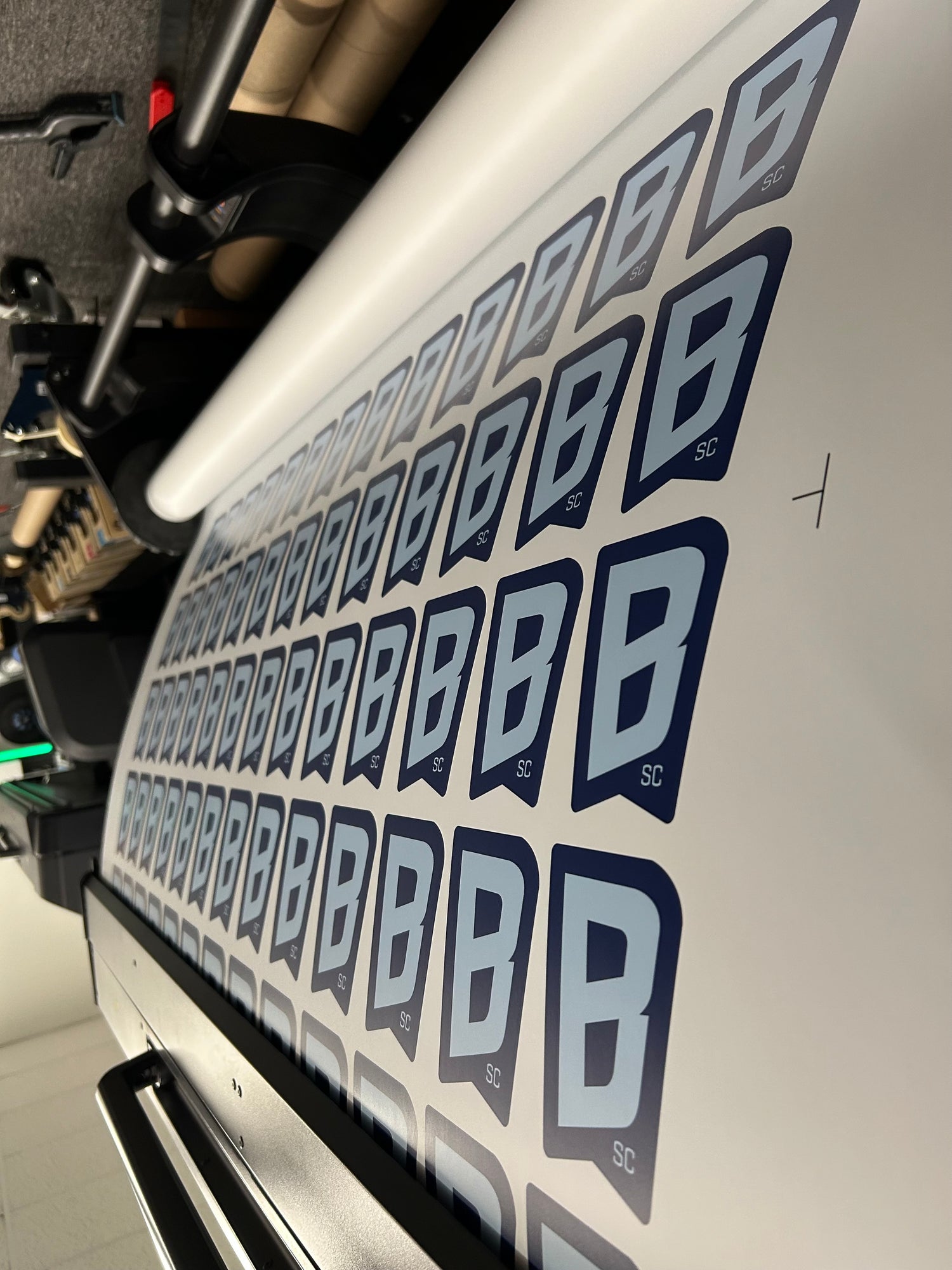 Close-up of a motorcycle with multiple 'B' decals on a white background