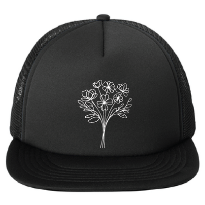 Black trucker cap with white floral design on a white background