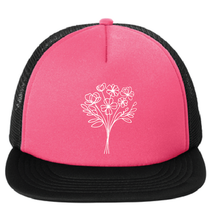 Pink trucker hat with black mesh back and white floral design on a white background