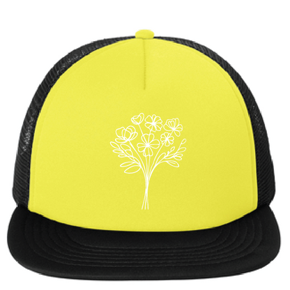 Yellow and black cap with a white floral design on a white background