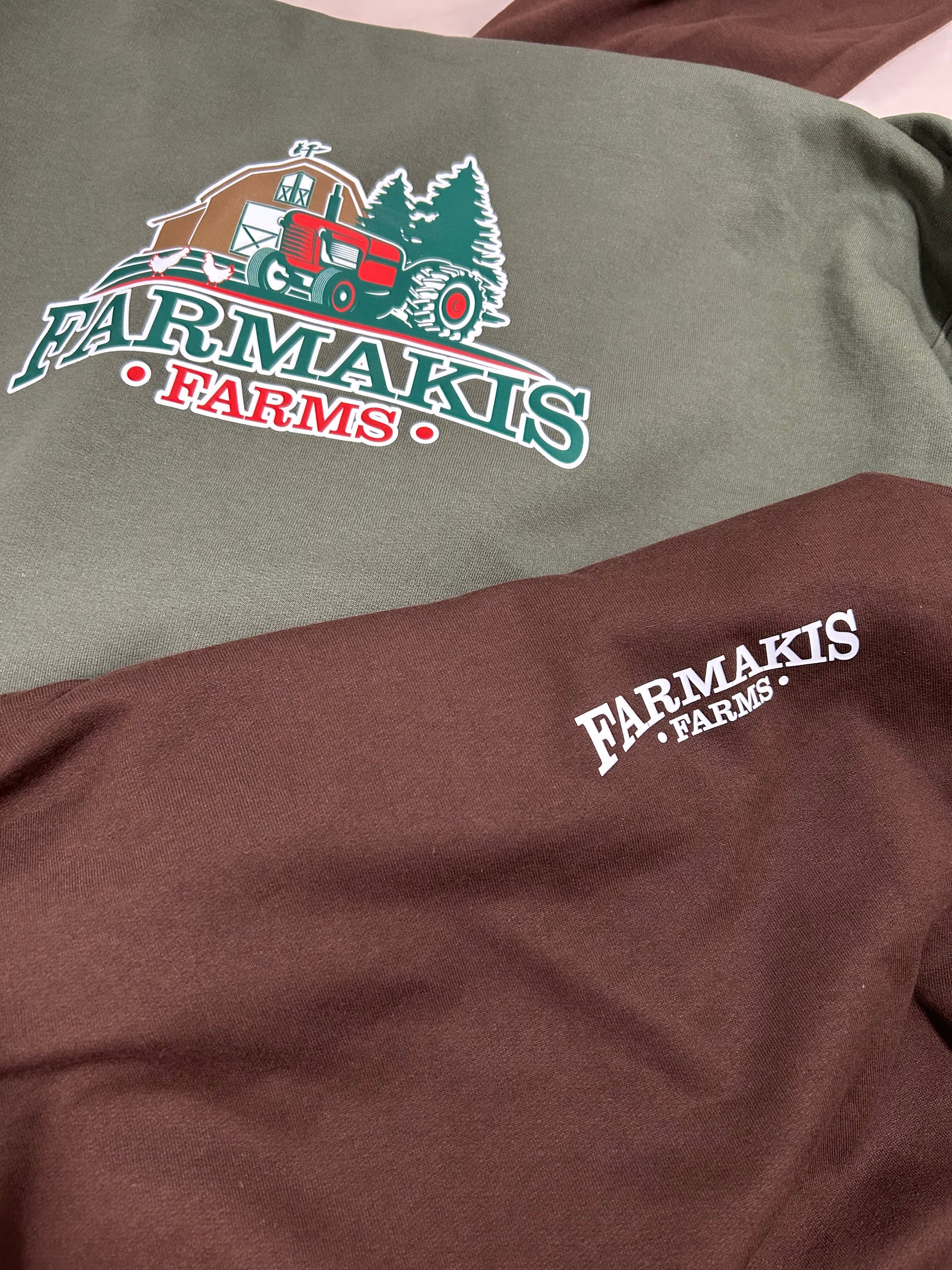 Two shirts with Farmakis Farms logo on a plain background