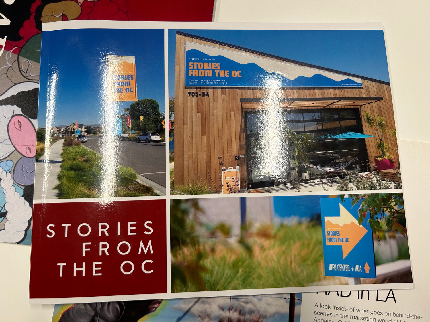 Book titled 'Stories from the OC' with images of a building and outdoor scenes.