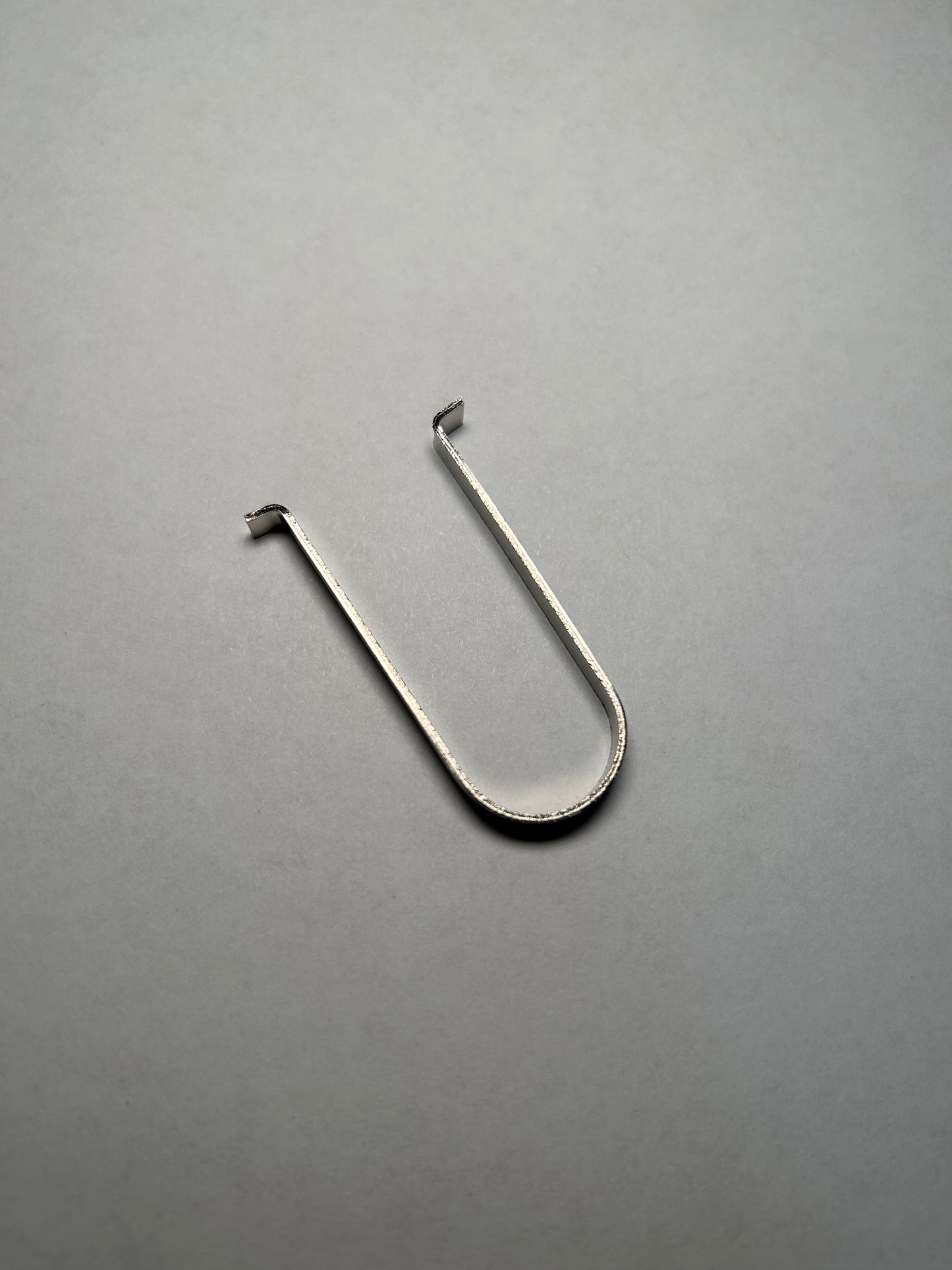 Metal hook on a gray background