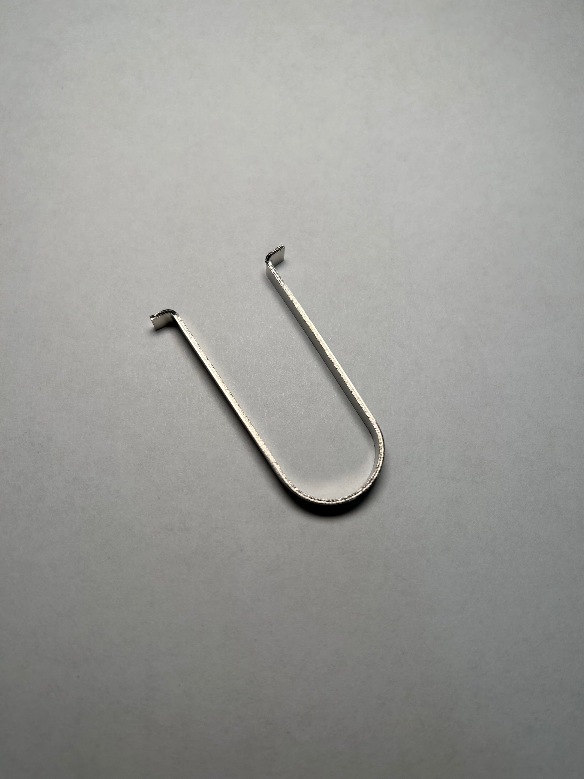 Metal hook on a gray background