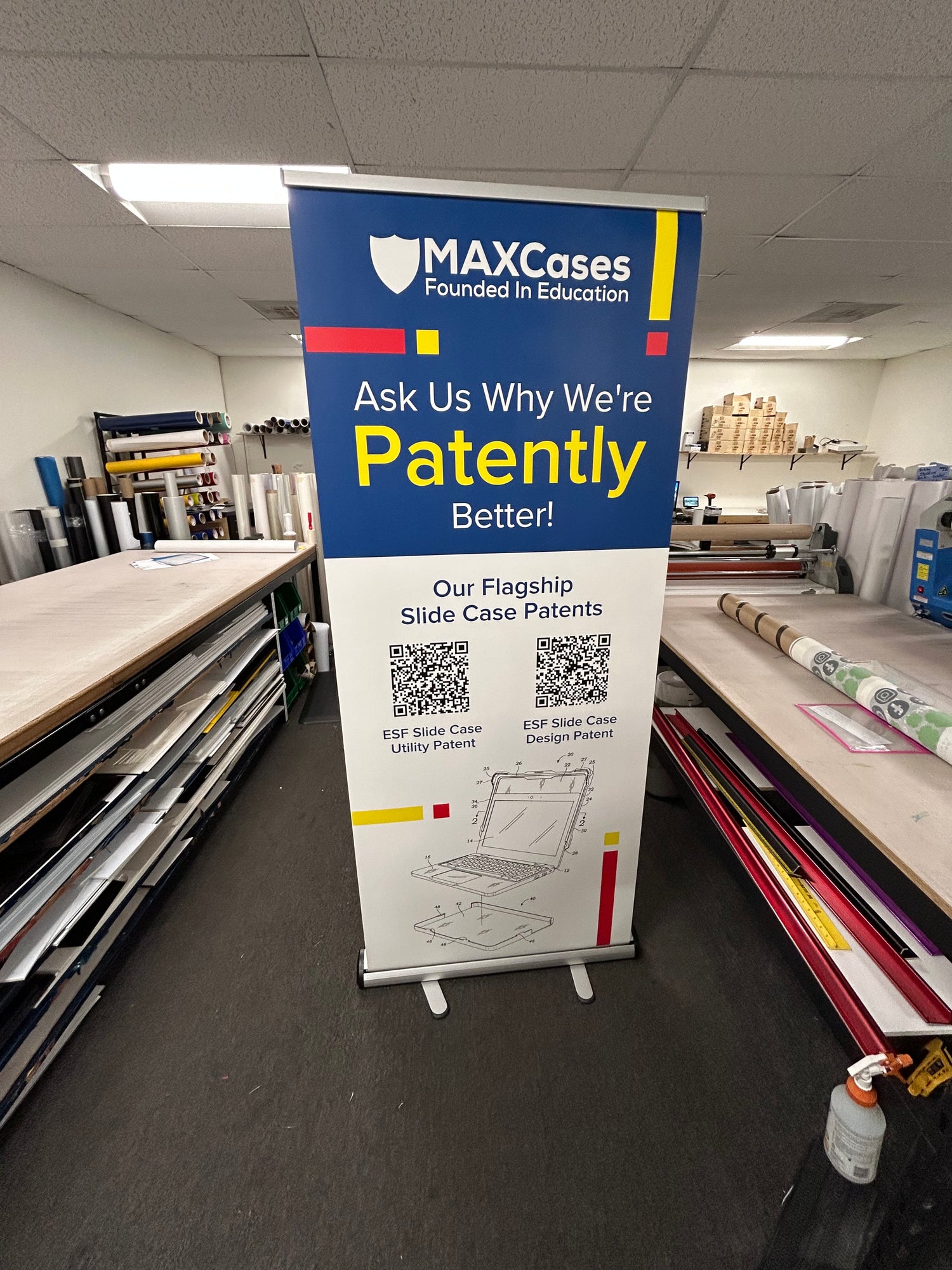 MaxCases promotional banner on a stand in an indoor setting
