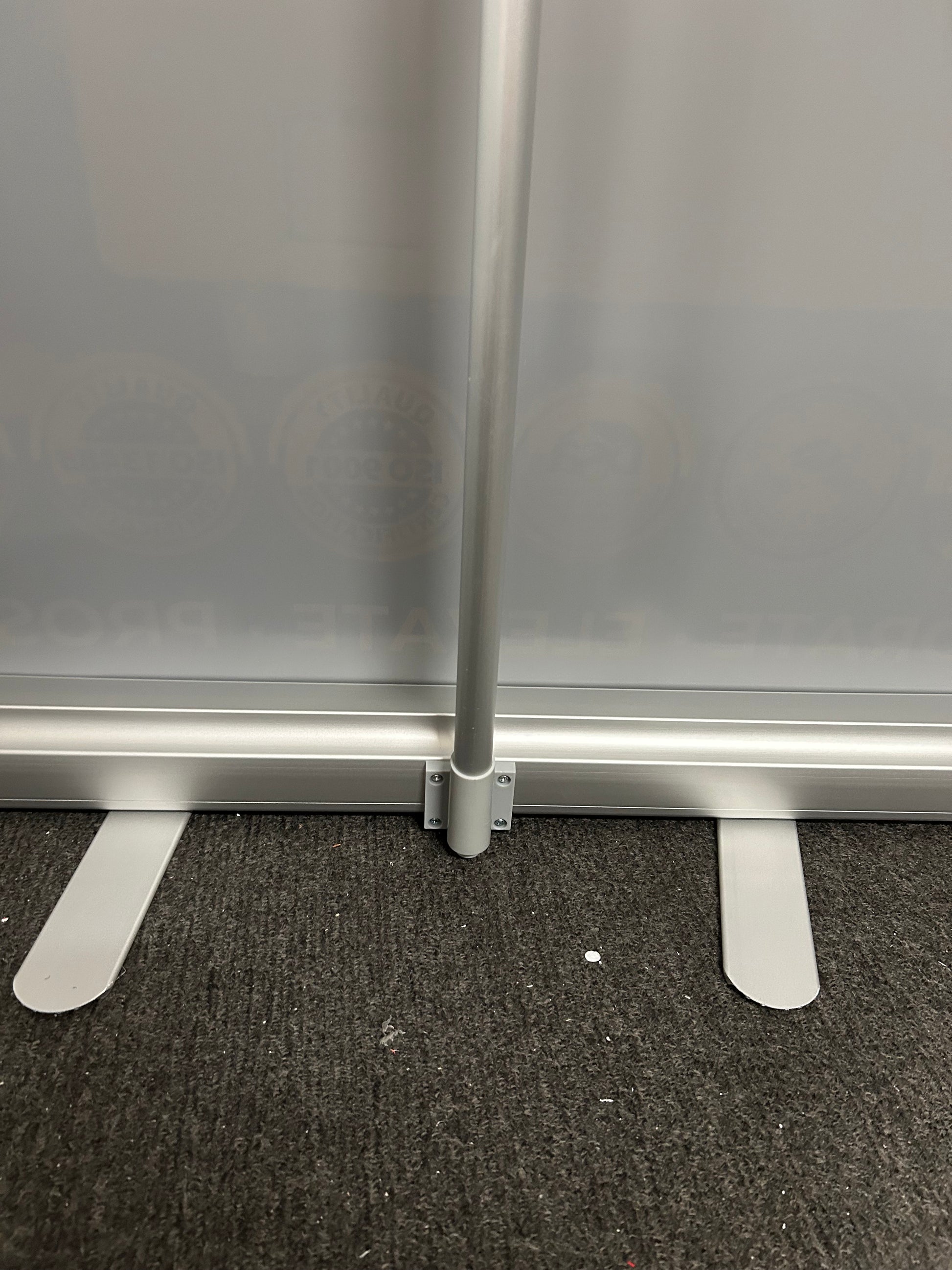 Metal bracket attached to a metallic surface with a textured black background