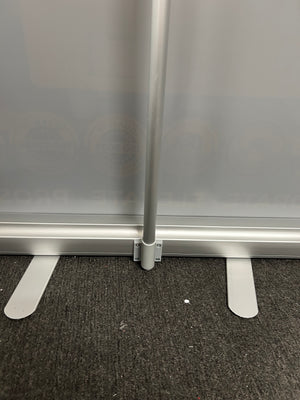 Metal bracket attached to a metallic surface with a textured black background