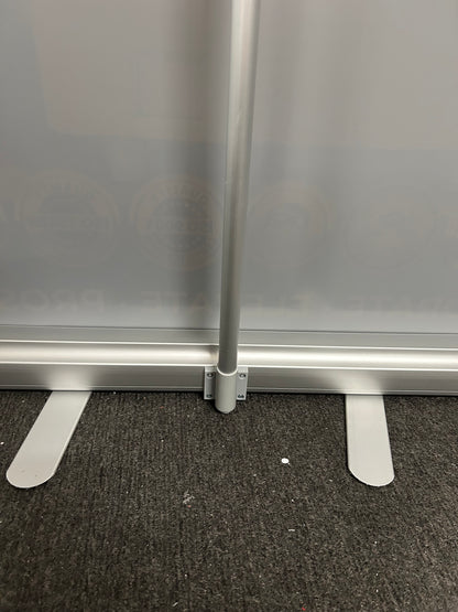 Metal bracket attached to a metallic surface with a textured black background