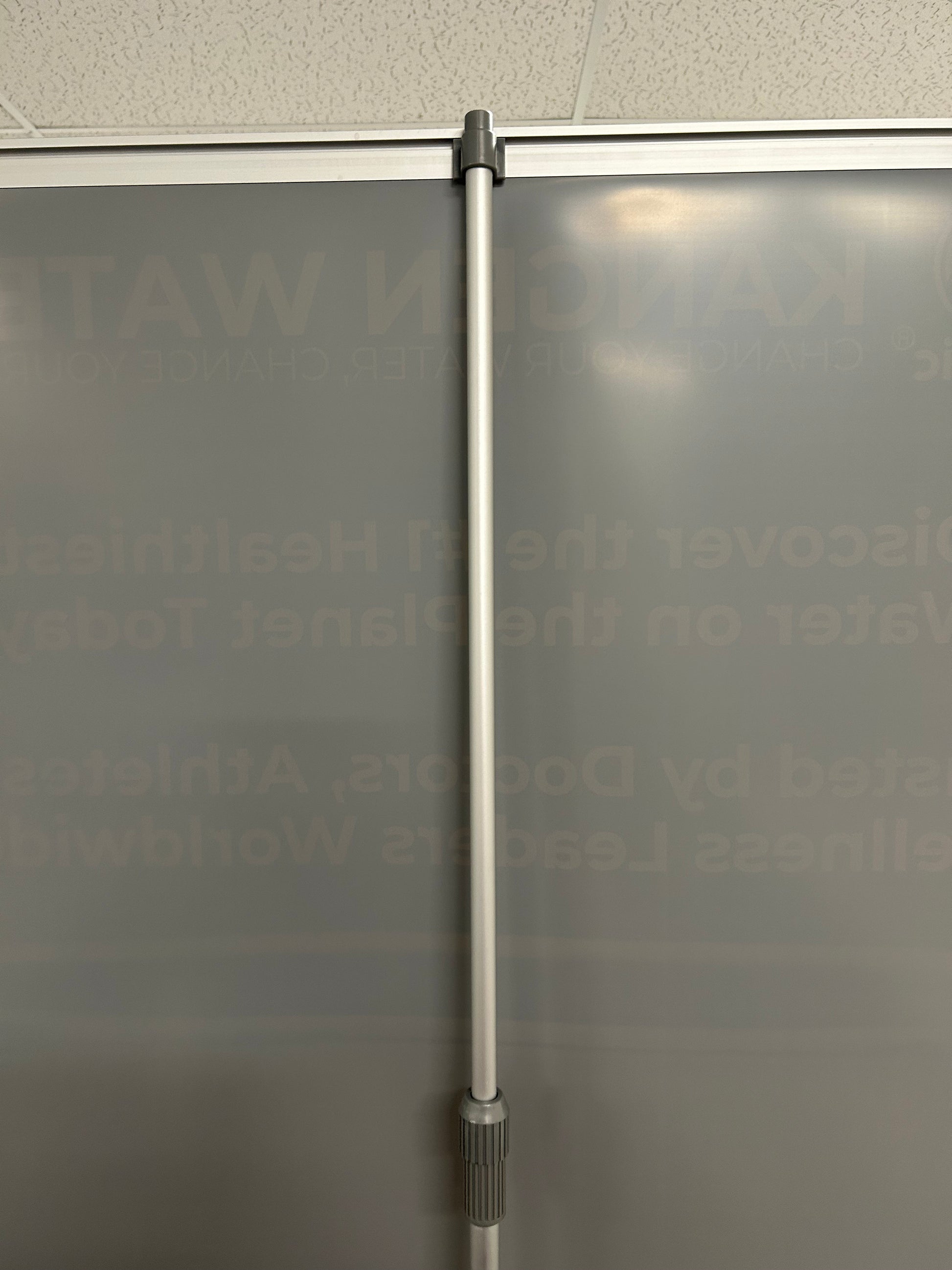 Metal rod against a textured glass surface with text