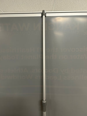 Metal rod against a textured glass surface with text
