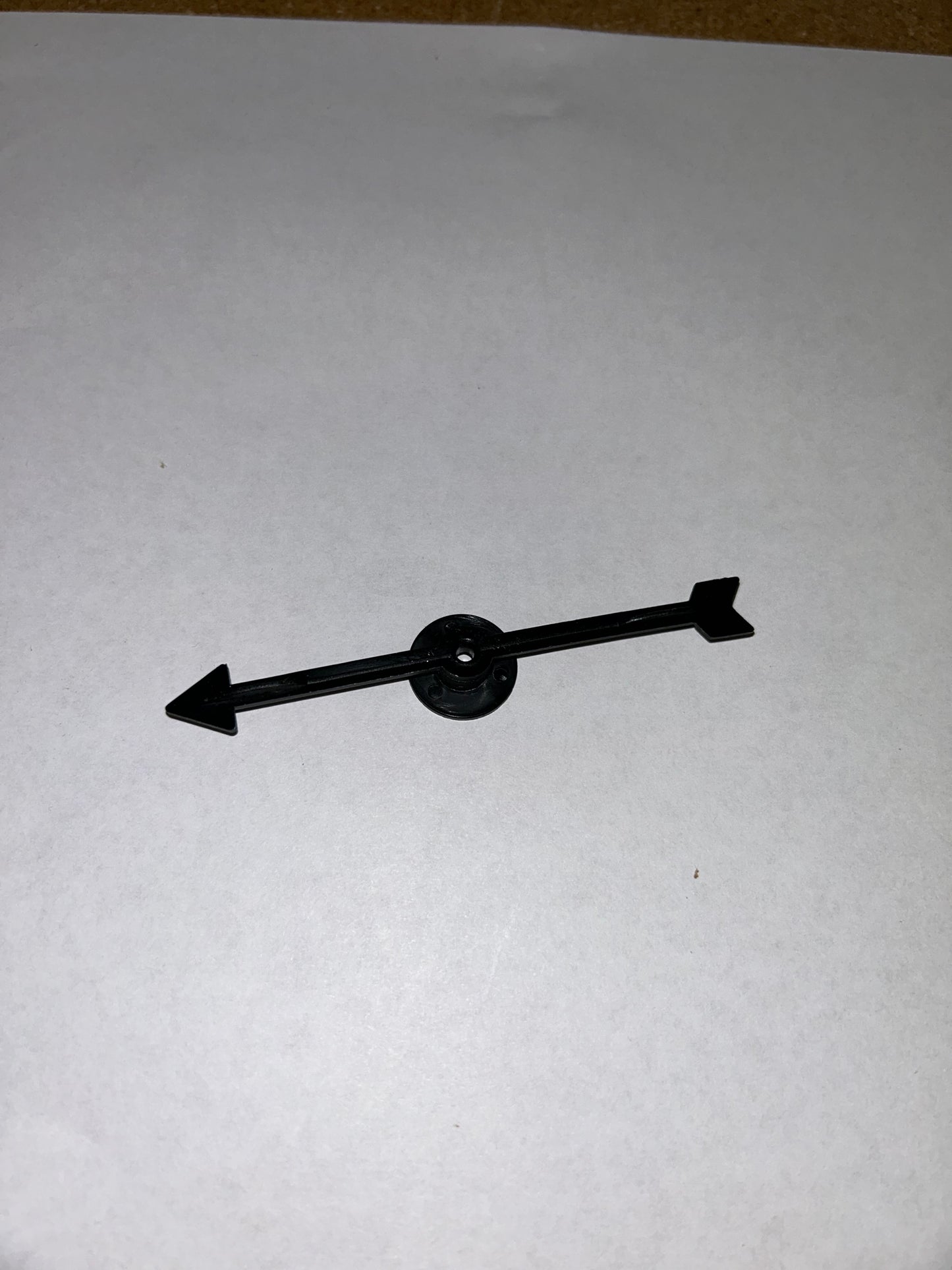 A collection of colorful plastic arrow spinners with a circular base, designed for use in board games and tabletop RPGs.