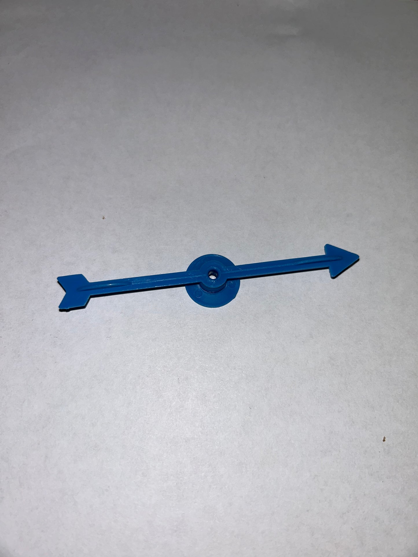 A collection of colorful plastic arrow spinners with a circular base, designed for use in board games and tabletop RPGs.