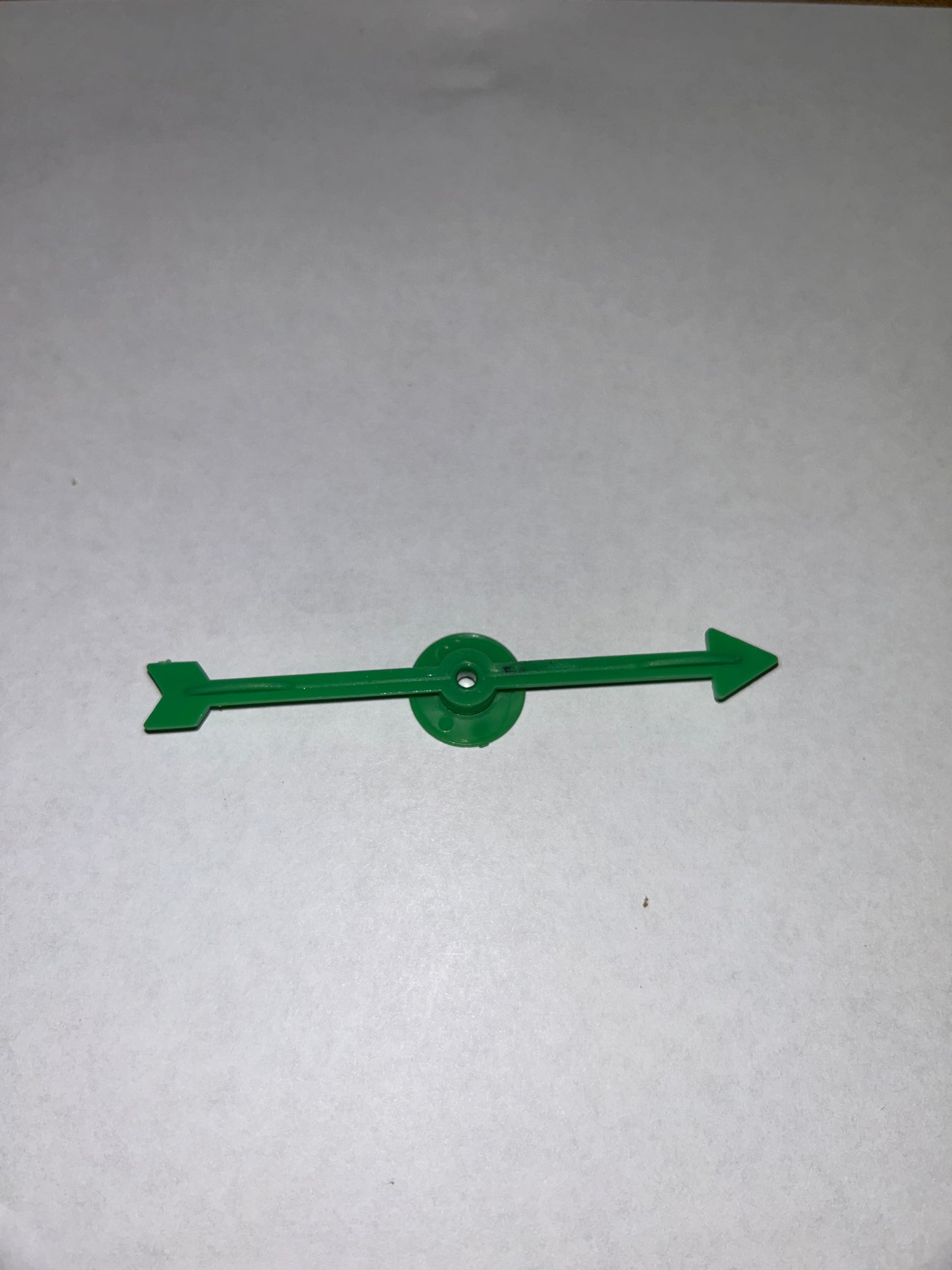 A collection of colorful plastic arrow spinners with a circular base, designed for use in board games and tabletop RPGs.