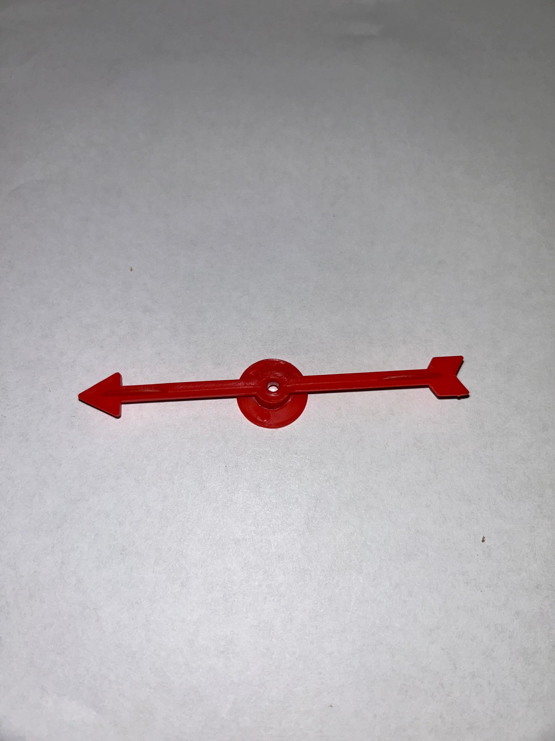 A collection of colorful plastic arrow spinners with a circular base, designed for use in board games and tabletop RPGs.