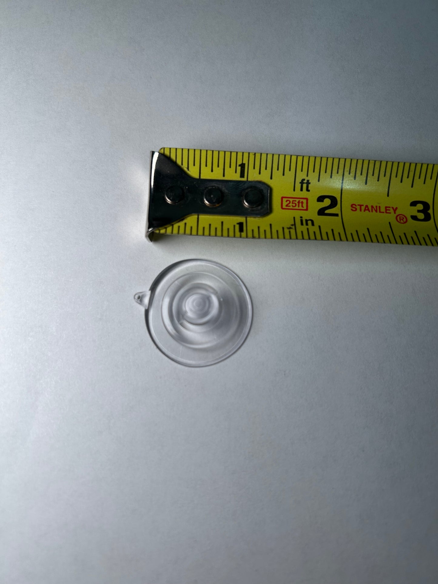 A suction cup with a metal clip attached, designed for sign post mounting.