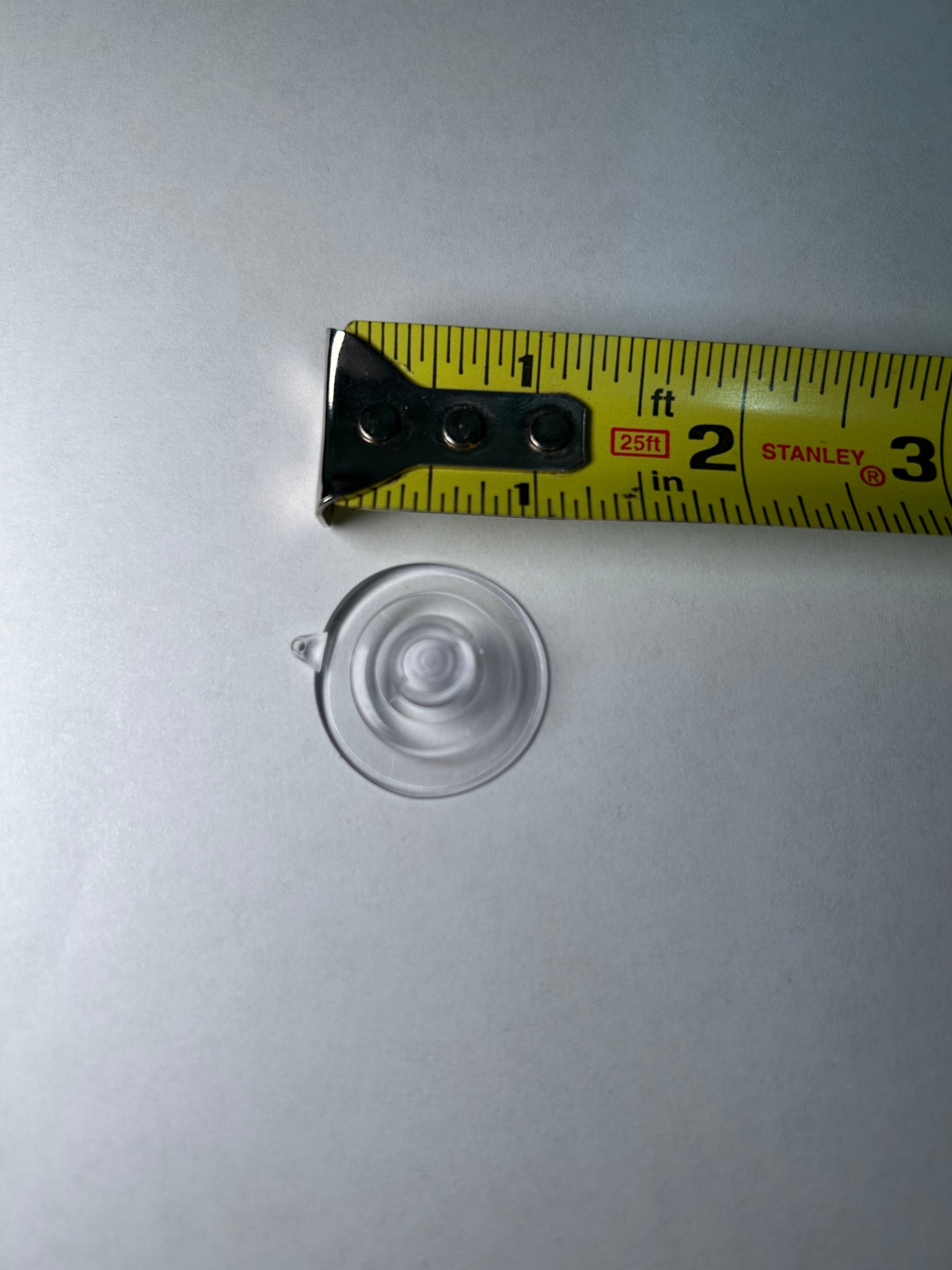 A suction cup with a metal clip attached, designed for sign post mounting.