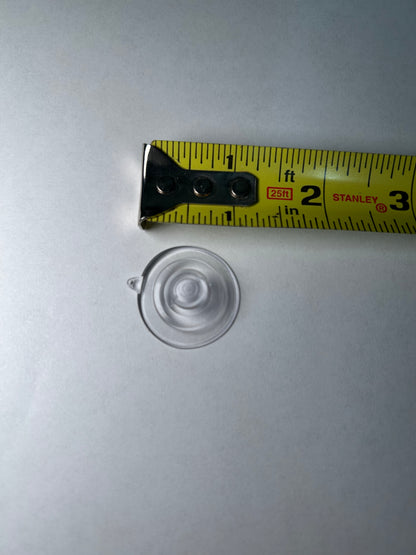 A suction cup with a metal clip attached, designed for sign post mounting.