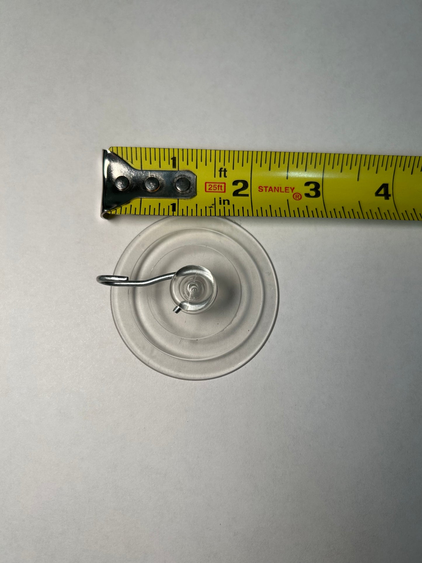 A suction cup with a metal clip attached, designed for sign post mounting.