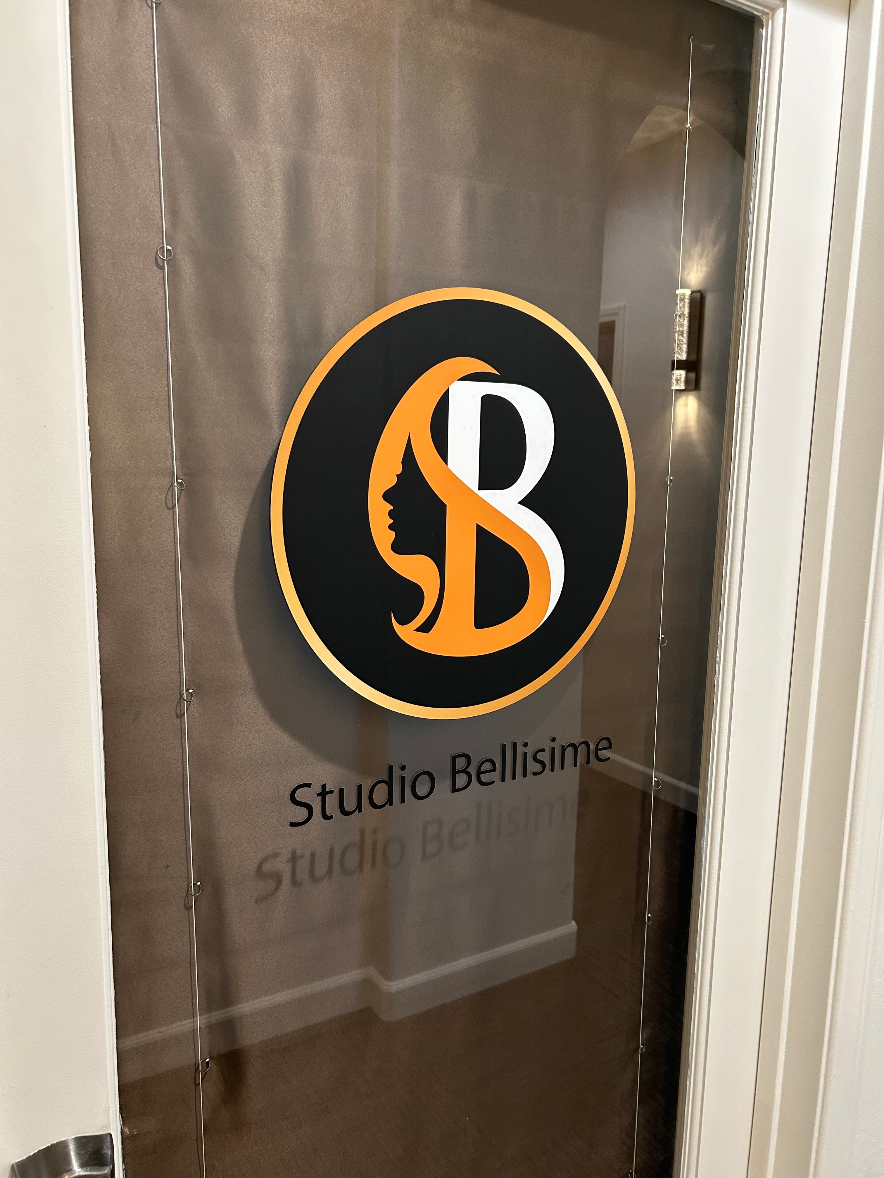 Logo of Studio Bellissime on a glass surface
